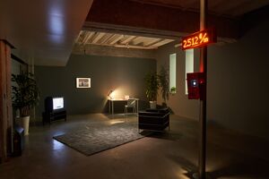 Exhibition view: A dark room with multiple objects
