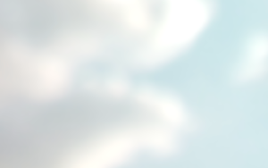 A blurred image of a blue sky with clouds